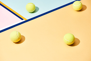 Tennis balls with shadow on colorful background with blue lines