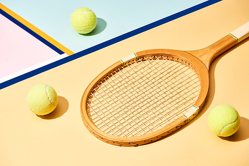 Tennis racket and balls on colorful background with blue lines