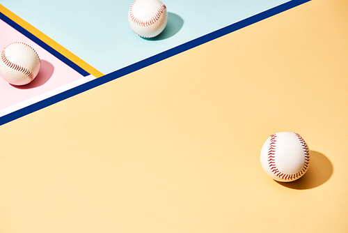White baseball balls on colorful background with lines