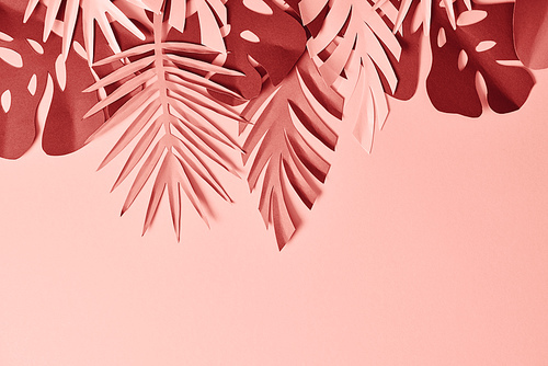 top view of colorful decorative paper cut palm leaves on pink background, panoramic shot