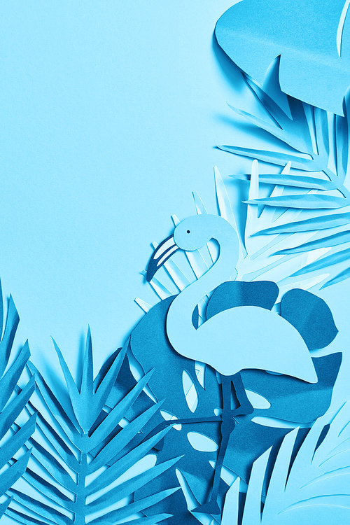 top view of blue minimalistic paper cut palm leaves and flamingo on blue background with copy space
