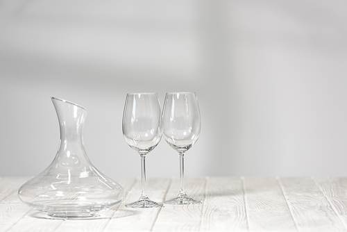 empty wine glasses and jug on wooden surface in restaurant