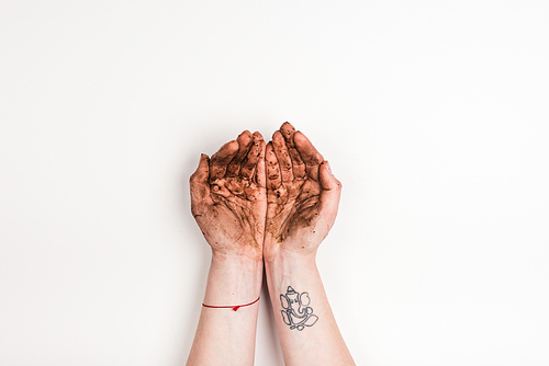 cropped view of woman with dirty hands on white