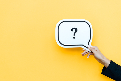 cropped view of woman holding speech bubble with  question mark on orange