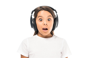 shocked kid listening music in headphones isolated on white