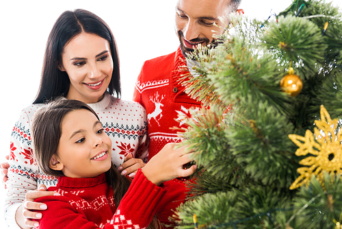 happy kid decorating christmas tree near parents isolated on white