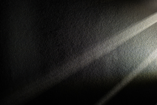 light prism with beams on dark textured background