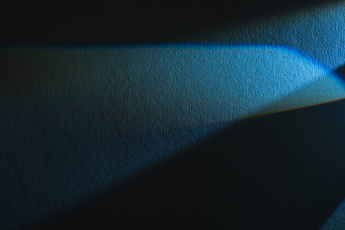 light prism with beam on blue and black texture background