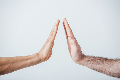 Cropped view of men doing high five isolated on grey