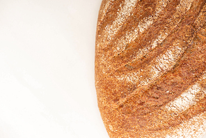 top view of fresh bread loaf on white background with copy space