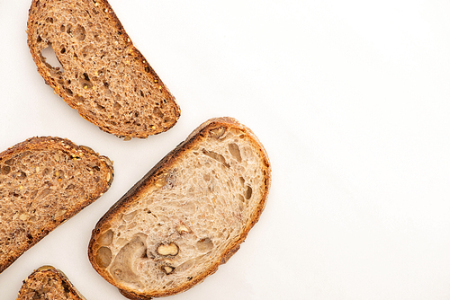 top view of tasty whole grain bread slices on white background with copy space