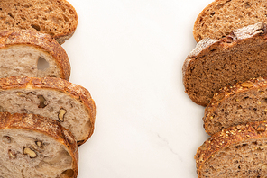 top view of fresh whole wheat bread slices on white background with copy space