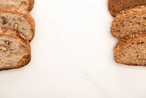 top view of fresh whole wheat bread slices on white background with copy space