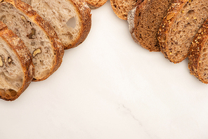 top view of whole wheat bread slices on white background with copy space