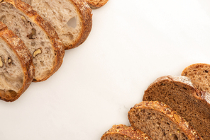 top view of whole wheat bread slices on white background with copy space