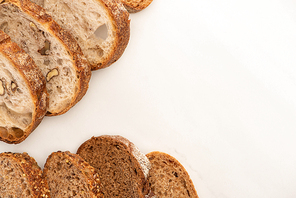 top view of whole wheat bread slices on white background with copy space