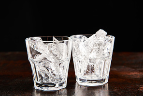 glass with frosted ice cubes isolated on black