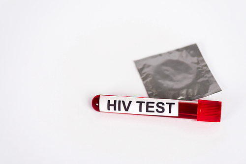 sample with hiv test near condom in pack isolated on white