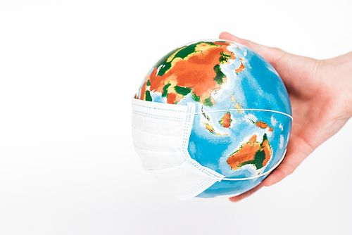 cropped view of man holding globe in protective mask isolated on white