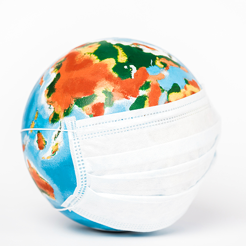 close up of globe in medical mask on white