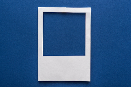 top view of empty paper white on blue background