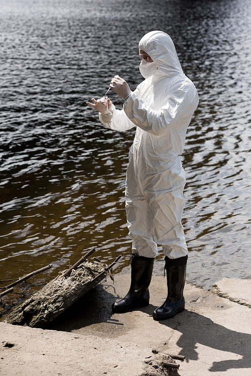 Water Inspector full length view of water inspector in protective costume, latex gloves ...
