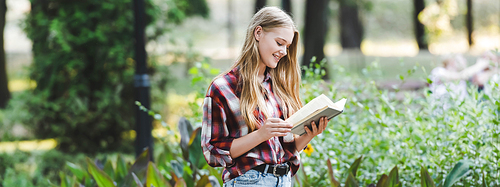 panoramic shot of beautiful girl in casual clothes reading book