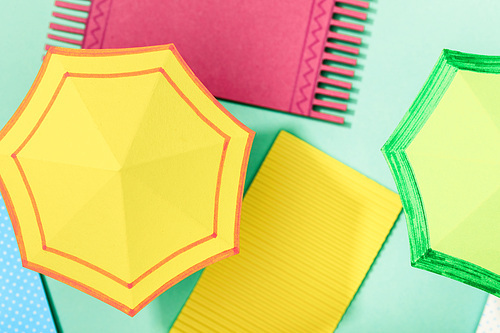 close up view of paper towels and umbrellas on turquoise background