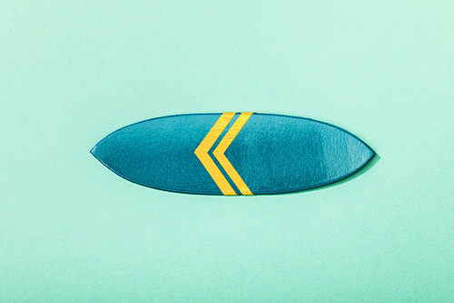 top view of paper towel and umbrella on turquoise background