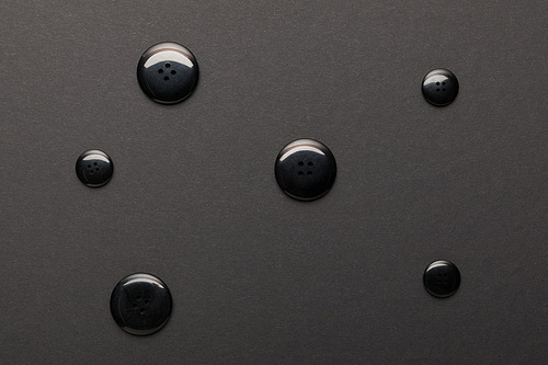 top view of clothing buttons isolated on black