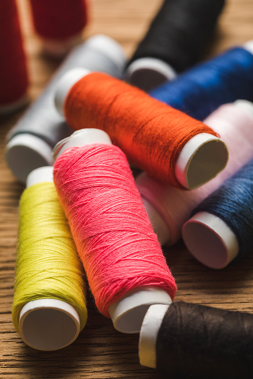 close up view of scattered colorful cotton thread coils