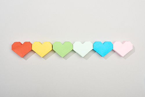 Top view of paper hearts on grey background