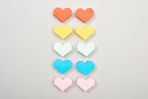 Top view of decorative paper hearts on grey background