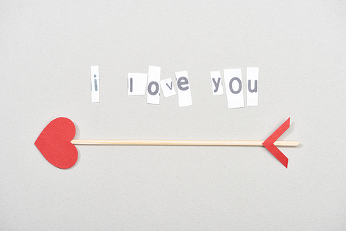 Top view of i love you lettering with arrow on grey background