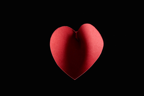 Top view of paper heart with shadow isolated on black