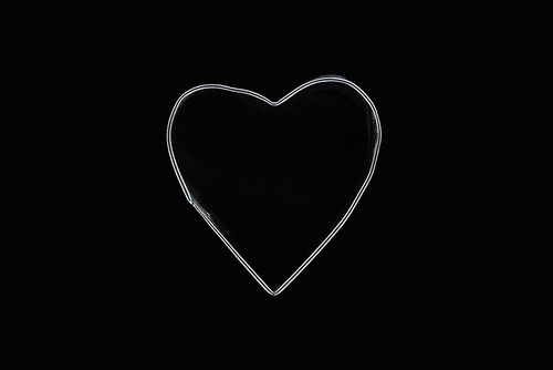 Top view of metal wire in heart shape isolated on black