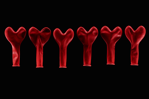 Top view of red heart shaped balloons isolated on black