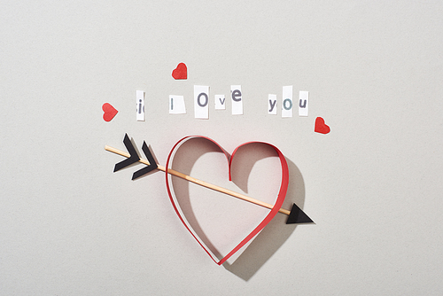 Top view of paper hearts with arrow and i love you lettering on grey background