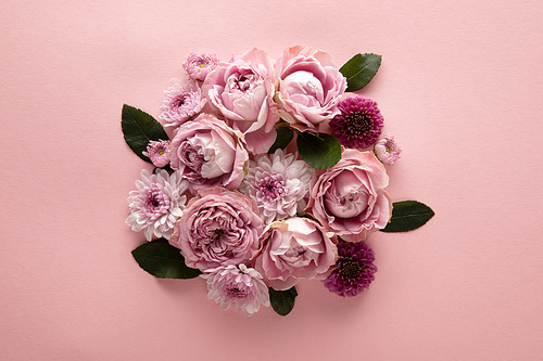 top view of blooming spring flowers in bouquet on pink background