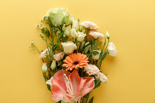 top view of spring floral bouquet on yellow background