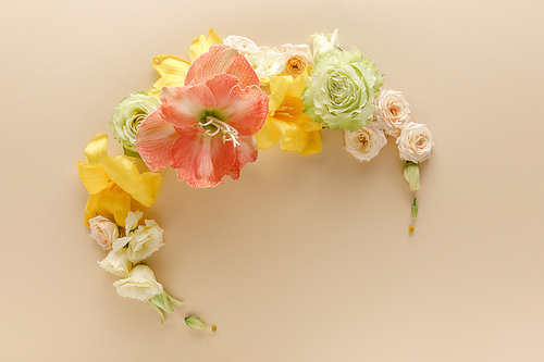 top view of spring floral wreath on beige background