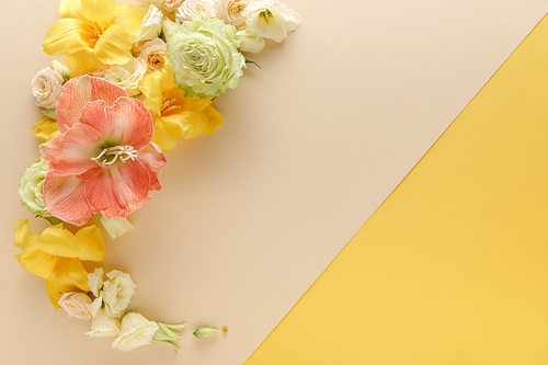 top view of spring floral bouquet on beige and yellow background