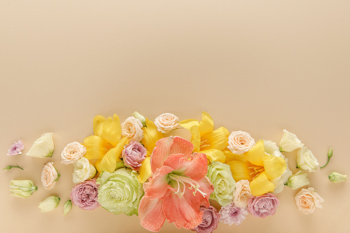 top view of spring floral bouquet on beige background