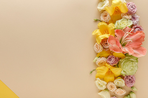 top view of spring floral border on beige and yellow background