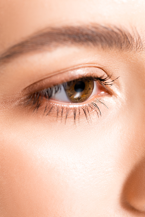 close up view of woman with brown clear eye and perfect skin
