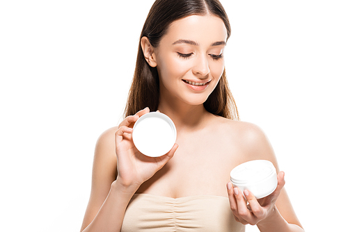 beautiful happy young woman with perfect skin looking at cosmetic cream isolated on white