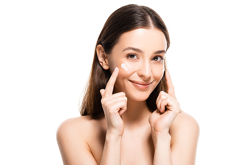 beautiful smiling naked woman with perfect skin pointing with fingers at cosmetic cream on face isolated on white