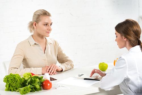 dietitian and patient at table with fresh food