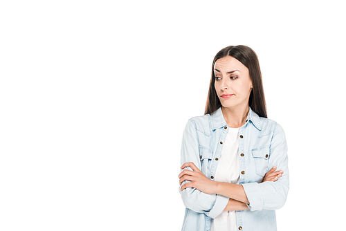 skeptical brunette woman standing with crossed arms isolated on white