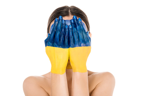 naked young woman with painted Ukrainian flag on hand and obscure face isolated on white